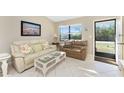 Cozy living room featuring tile flooring, neutral paint, and plenty of natural light at 7522 Sea Mist Dr, Port Charlotte, FL 33981