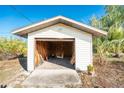 Exterior shot of the outbuilding, offering extra storage and functionality to the property at 7522 Sea Mist Dr, Port Charlotte, FL 33981