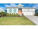 Coastal-style home with light-colored siding and a gray paver driveway at 8960 Scallop Way, Placida, FL 33946