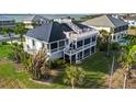 Two-story home with a large deck and screened porch at 9860 Eagle Preserve Dr, Englewood, FL 34224