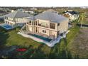 Aerial view showcasing a backyard with a pool, lush green lawn, and outdoor living space, perfect for relaxation at 9861 Eagle Preserve Dr, Englewood, FL 34224