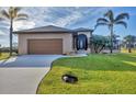 Single-story home with attached garage and nicely landscaped lawn at 1 Calm Ct, Placida, FL 33946