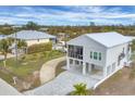 Aerial view of two-story home with paved driveway and landscaping at 10451 Sherman St, Englewood, FL 34224