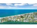 Breathtaking aerial view of the coastal community with pristine white sandy beach and turquoise waters at 1100 Gulf Blvd, Englewood, FL 34223