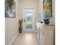 Bright entryway with decorative console table and artwork at 13489 Abercrombie Dr, Englewood, FL 34223