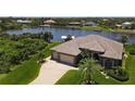 Bird's-eye view of a single-Gathering home on a waterfront lot at 14201 Joggins Ave, Port Charlotte, FL 33981