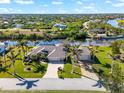 Aerial view of waterfront home showcasing canal and neighborhood views at 14216 Aurella Cir, Port Charlotte, FL 33981