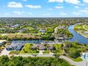 Wide aerial view of a home with a large lot and canal access at 14216 Aurella Cir, Port Charlotte, FL 33981