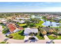 Lovely one-story home in a lakeside community, showcasing lush landscaping and neighborhood views at 1443 Quail Lake Dr, Venice, FL 34293