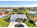 Charming single-story home with tropical landscaping situated in a serene neighborhood near a tranquil pond at 1443 Quail Lake Dr, Venice, FL 34293