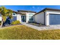 Two-story home with a charming front porch and landscaping at 15410 Seafoam Cir, Port Charlotte, FL 33981