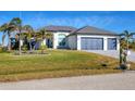 Single-Gathering home with two-car garage and manicured lawn at 15410 Seafoam Cir, Port Charlotte, FL 33981