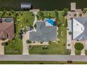 Bird's-eye view of house, pool, and canal at 15794 Viscount Cir, Port Charlotte, FL 33981