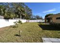 Large grassy backyard with a white fence and pergola at 1755 Georgia Ne Ave, St Petersburg, FL 33703