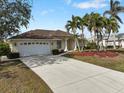 Single story home with attached garage and mature landscaping at 2295 Chilcote Ter, Port Charlotte, FL 33981