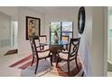 Cozy dining area with a glass top table, seating for four, a decorative mirror, and a stylish area rug at 232 Southampton Ln # 259, Venice, FL 34293