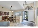 Elegant dining room with tile floors, shuttered window and an arched doorway at 235 Capstan Dr, Placida, FL 33946