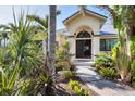 Inviting front entrance with beautiful landscaping and an arched doorway at 235 Capstan Dr, Placida, FL 33946