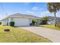 Single-story home with a two-car garage and a well-manicured front lawn at 254 Mark Twain Ln, Rotonda West, FL 33947