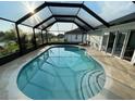 Inviting screened pool with a large patio area at 254 Mark Twain Ln, Rotonda West, FL 33947