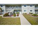 Condo building exterior, showing entrance and landscaping at 3310 Loveland Blvd # 802, Punta Gorda, FL 33980