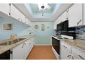 Bright kitchen with granite countertops and white cabinets at 3310 Loveland Blvd # 802, Punta Gorda, FL 33980