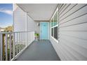 Condo exterior showing light blue door and walkway at 4410 Warren Ave # 403, Port Charlotte, FL 33953