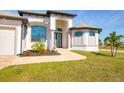 Front entrance with columns and a walkway leading to the house at 48 Master Dr, Placida, FL 33946