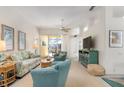 Relaxing living room featuring a sofa, armchairs, and coastal decor at 523 Fallbrook Dr, Venice, FL 34292