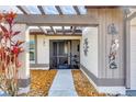 Front entry with a pergola and walkway at 545 Foxwood Blvd # 23, Englewood, FL 34223