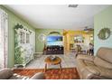 Comfortable living room with tile flooring, unique decor, and a view into the dining area at 6543 Coliseum Blvd, Port Charlotte, FL 33981