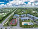 Gorgeous aerial view of the community highlighting the pool, tennis courts and golf course at 6800 Placida Rd # 122, Englewood, FL 34224