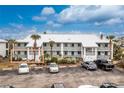 Condo exterior showing multiple units, landscaping, and ample parking at 6800 Placida Rd # 122, Englewood, FL 34224