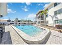 Inviting community pool with ample deck space for lounging at 708 Tamiami S Trl # 103, Venice, FL 34285