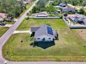 Single-story home with solar panels and a large grassy area at 7179 Lighthouse St, Englewood, FL 34224