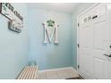 Bright entryway with a bench and beach-themed decor at 7586 Sea Mist Dr, Port Charlotte, FL 33981