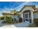 Front entrance with a screened porch and lush landscaping at 8 Sportsman Rd, Rotonda West, FL 33947