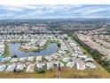 Aerial view of a manufactured home community near a lake at 844 Seabrooke Ct, Englewood, FL 34223