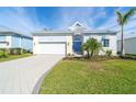 A light blue one-story house with a white garage and blue door at 8768 Conch Ave, Placida, FL 33946