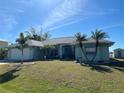 House exterior with landscaping and palm trees at 9458 Melody Circle, Port Charlotte, FL 33981