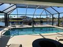 Relaxing pool area with covered patio and canal view at 9458 Melody Circle, Port Charlotte, FL 33981