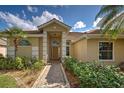 Eye-catching front entrance with a classic-style door and professionally landscaped garden at 1216 Whitney Dr, Venice, FL 34293