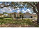 Inviting one-story home with a well-manicured lawn and lush landscaping at 1216 Whitney Dr, Venice, FL 34293