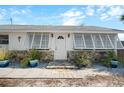 A home with an inviting front entrance with stone accents and shuttered windows at 1495 New Point Comfort Rd, Englewood, FL 34223