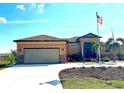 House exterior with a two-car garage and American flag at 15204 Aquarius Cir, Port Charlotte, FL 33981