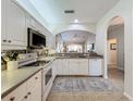White kitchen with stainless steel appliances and view to living area at 1577 Monarch Dr # 1577, Venice, FL 34293