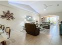 Living room with vaulted ceiling, comfortable seating, and natural light at 1577 Monarch Dr # 1577, Venice, FL 34293
