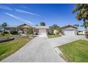 Two-story home with attached garage, landscaping, and spacious driveway at 18198 Burkholder Cir, Port Charlotte, FL 33948