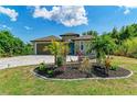 One-story home with teal door, paver driveway, and landscaped yard at 237 Albatross Rd, Rotonda West, FL 33947