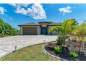 One story home with teal door and paver driveway at 237 Albatross Rd, Rotonda West, FL 33947